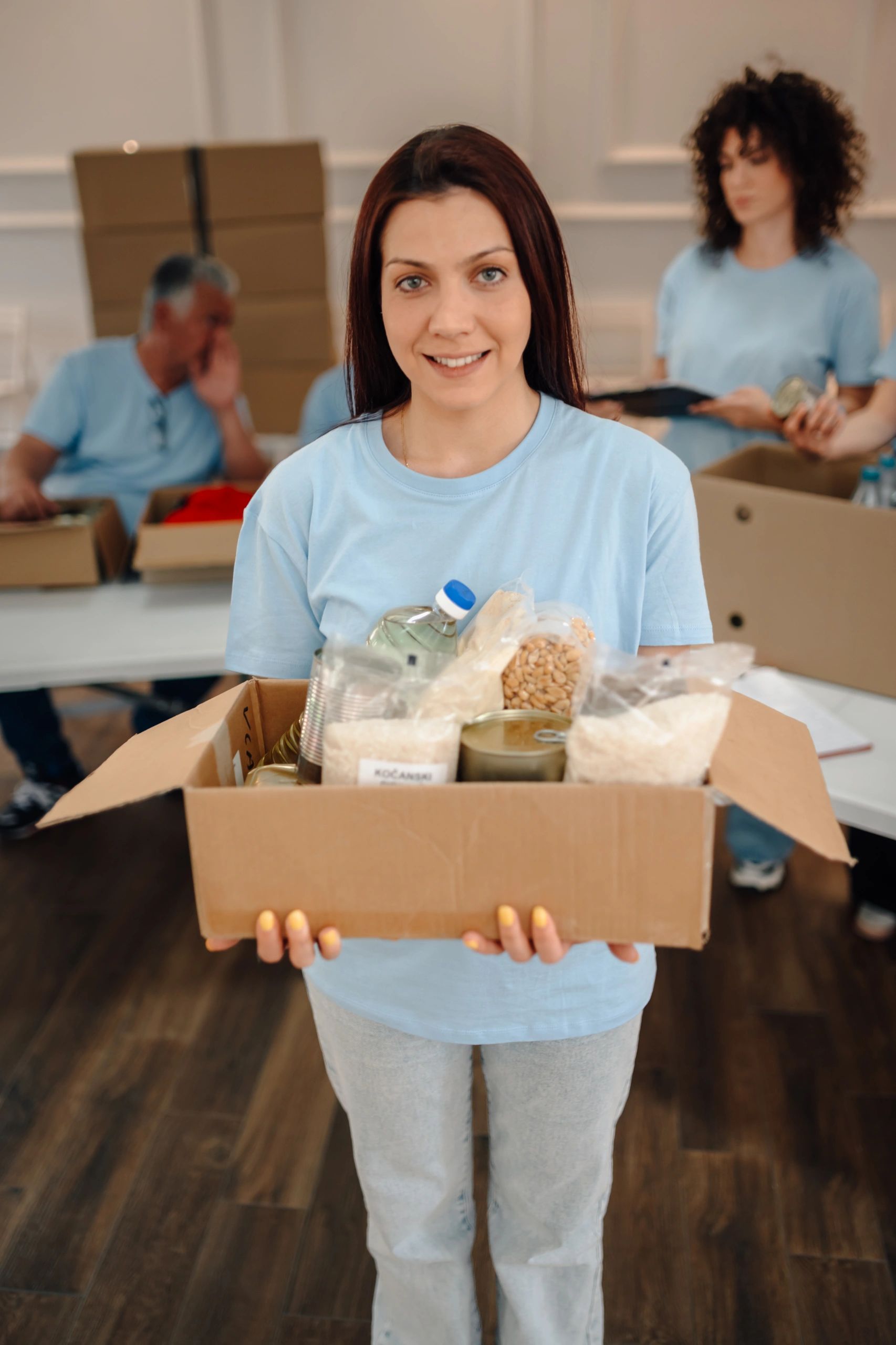 Community service provider holding a donation box